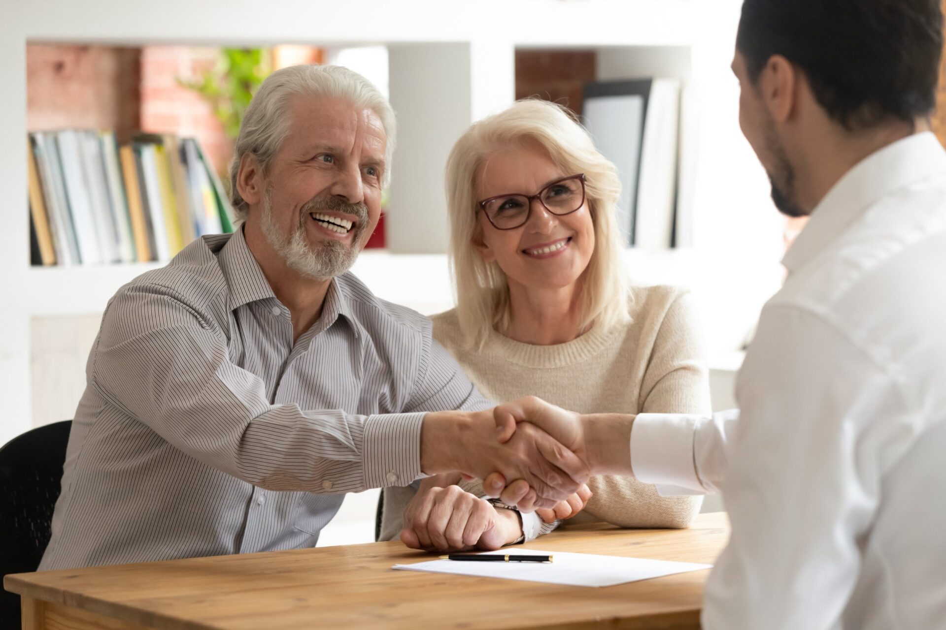 parents selling home to son utilizing a gift of equity, handshake over signing of gift of equity letter
