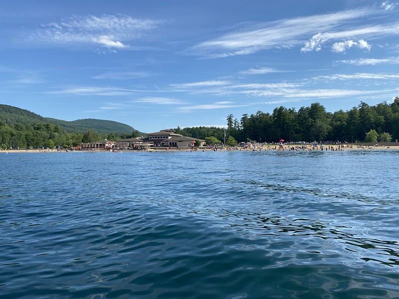 view crowded lakefront beach from the water